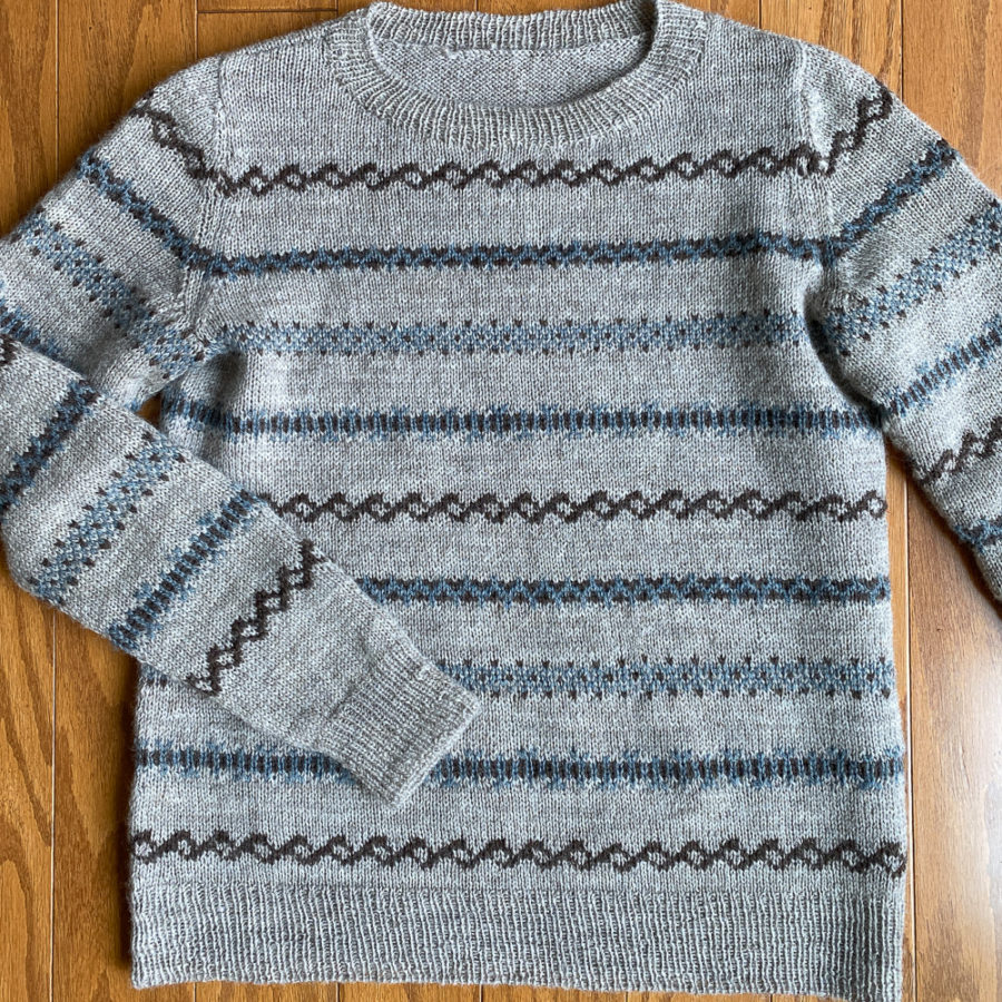 Ashland sweater in taupe main colour and light blue and dark brown accent colours.